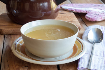 Bone broth made from chicken served in a soup bowl