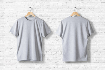 Blank Grey T-Shirts  Mock-up hanging on white wall, front and rear side view . Ready to replace...