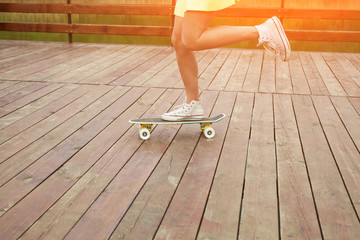 Girl riding cruiser on sunny day