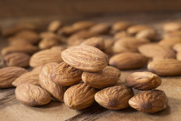 Almonds on wooden table - Prunus dulcis