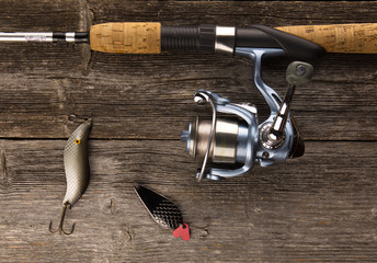 spinning rod  And bait on a wooden background