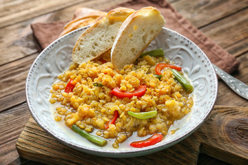 Composition with tasty lentil dish on wooden table, closeup