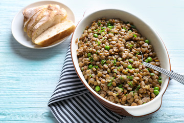 Composition with tasty lentil porridge on light wooden table
