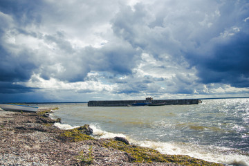Baltic sea shore in Estonia. Stormy weather and cloudy sky background.