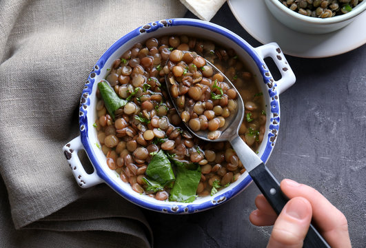 Hand Of Woman Eating Tasty Lentil Dish, Closeup