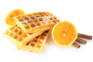 Delicious cinnamon waffles with orange isolated on white