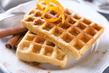 Delicious cinnamon waffles with orange zest, closeup