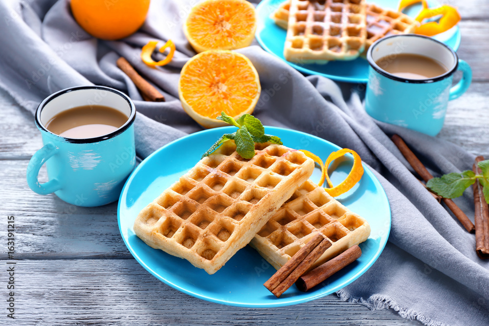 Wall mural Delicious cinnamon waffles with orange zest on table