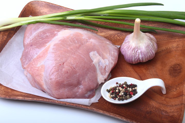 pork steaks with fat. Meat is on wooden board with spice as pepper and green spring onion. Ready for cooking. Selective focus.