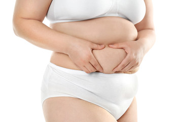 Overweight young woman in underwear on white background. Diet concept