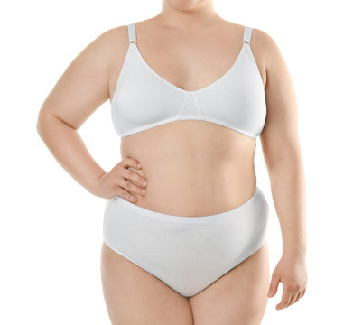 Overweight young woman in underwear on white background. Diet concept
