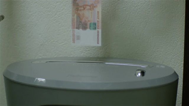 Woman's fingers put the banknote into the Schroeder