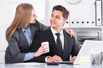 Businesswoman seducing male colleague
