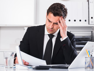 Frustrated businessman at office desk
