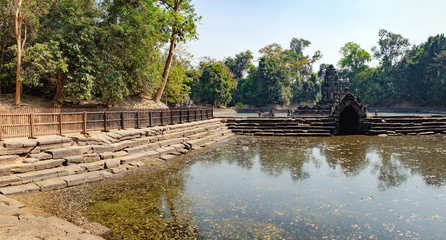 Fototapeta na wymiar The central pond at Neak Pean with ancient Khmer architecture, Angkor Complex, Siem Reap, Cambodia. Famous Cambodian landmark, World Heritage.