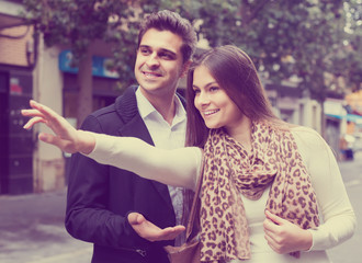  brunette showing direction to Indian guy at the street