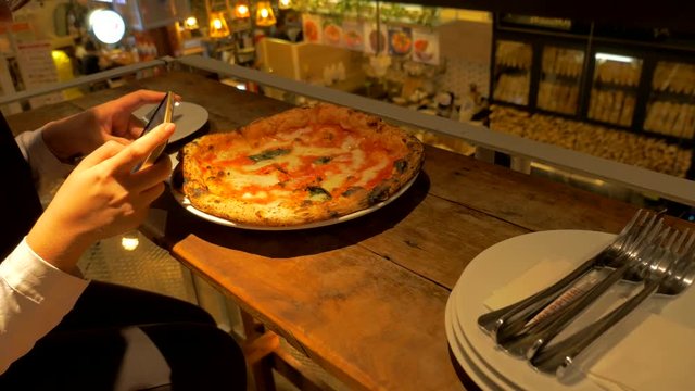 woman taking photo of  Delicious fresh and testy italian pizzas 