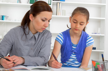 Fototapeta premium Mother Helping Daughter With Homework