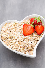 Dry rolled oatmeal in bowl.