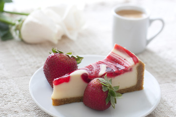 Cheesecake slice with strawberry and coffee