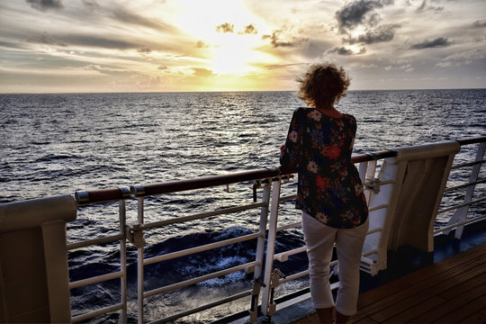 Lone Cruise ship Passenger Looking Out Over Ocean at Dusk