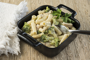 Pasta with chicken and broccoli in an individual baking pan