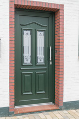 Fototapeta na wymiar Grüne Eingangstür eines Hauses