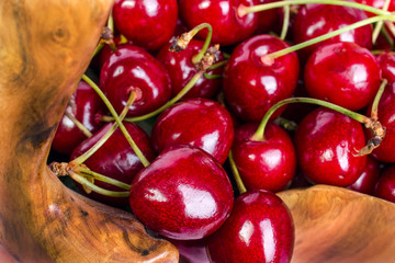 A lot of red ripe cherry lies close-up.