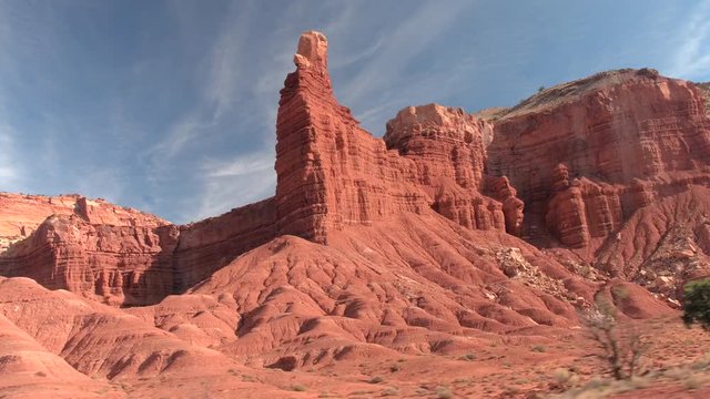 CLOSE UP: Big eroded butte and mesa mountains in red rocky desert on hot summer day. Driving past the rocky mountain formations in Utah, United states. Dry desert landscape in sunny Capitol Reef 