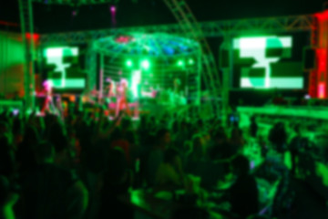 Obraz na płótnie Canvas Blurry night club dj party people enjoy of music dancing sound with colorful light. club night light dj party Ibiza club. With Smoke Machine and lights. Dark background.