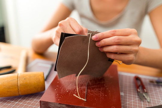 Woman making leather