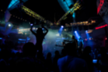 Fototapeta na wymiar Blurry night club dj party people enjoy of music dancing sound with colorful light. club night light dj party Ibiza club. With Smoke Machine and lights. Dark background.