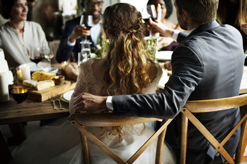 Bride and Groom Having Meal with Friends at Wedding Reception