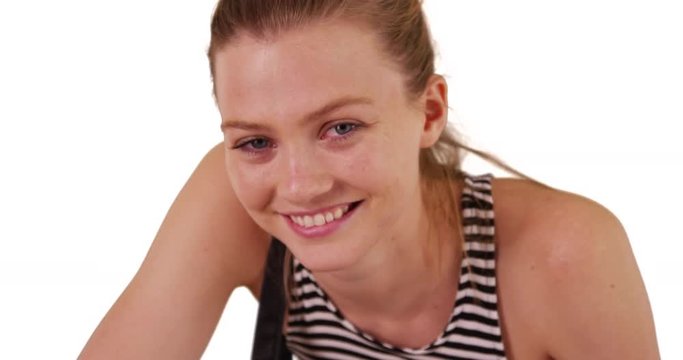 Cheerful young blonde woman looking at camera on copyspace