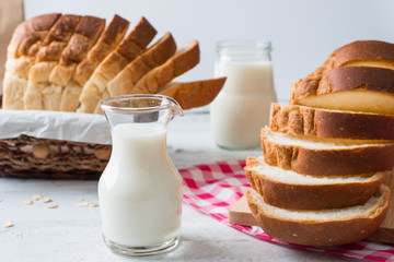 Fresh baked bread and sliced bread on rustic wooden table