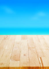 Wood table top on blur blue sea and sky background