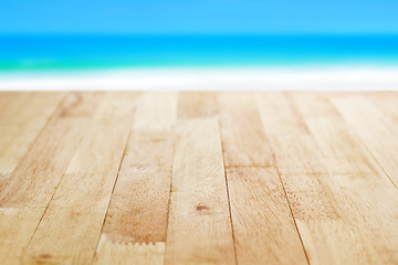 Wood table top on blur blue sea and white sand beach background, summer concept