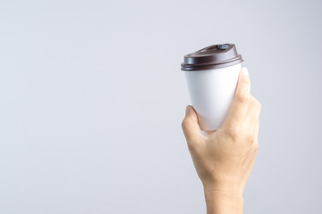 Hand holding hot coffee paper cup