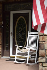 Old glory in historic Ligonier PA, perched on porch near rocking chair