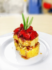 Colorful piece of cake with a jelly in a  white plate