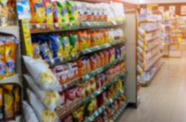 Grocery on shelf in small supermarket , blurred effect