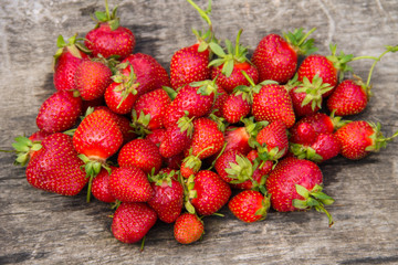 Ripe fresh strawberries on rustic wooden background. Top view