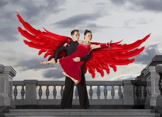 Angel wings. Pair of dancers dancing ballroom
