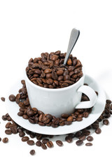 cup with coffee beans on white background, concept photo, closeup