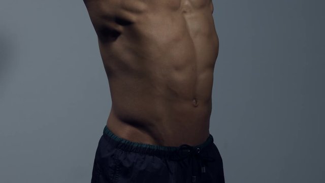 Bodybuilder stomach flexing muscles