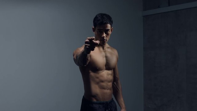 Muscular Asian Bodybuilder Pointing Finger 