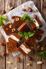 Delicious dessert: butterscotch with nuts and mint closeup on the table. vertical top view
