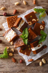 Caramel candy with nuts close-up on the table. vertical top view