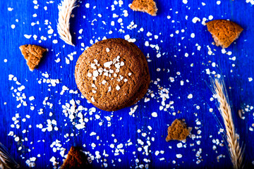 Oatmeal cookies on blue wooden background.  Towel of oat cookies. Top view.