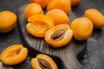  Apricots on a dark board. Dark background.